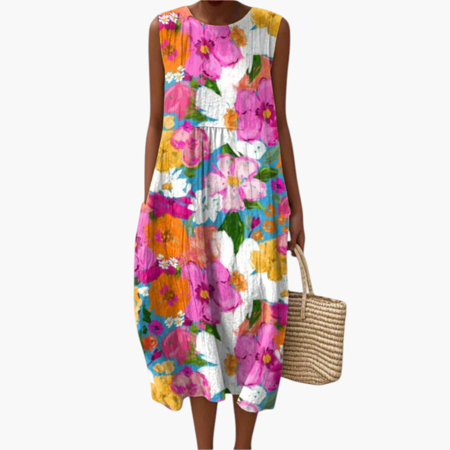 My Store 4 Eden™ Vibrant Floral Midi Dress met kleurrijke bloemenprint, mouwloos en lichtgewicht op het strand.
